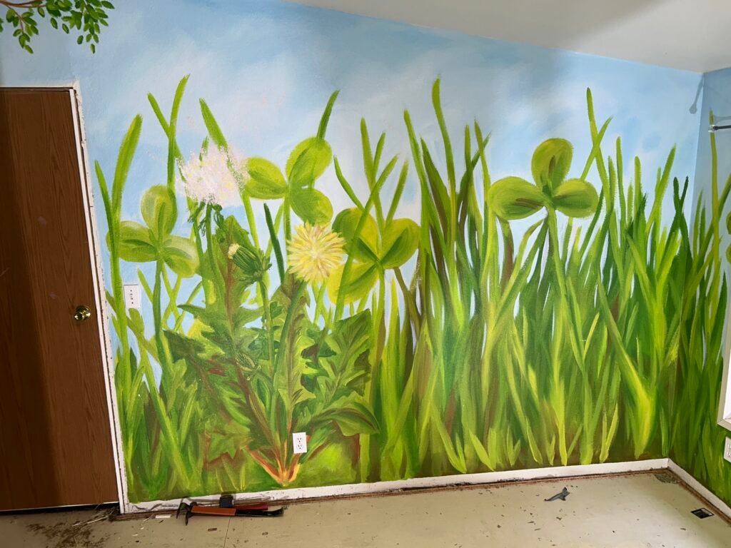 large grass and flowers painted on the wall