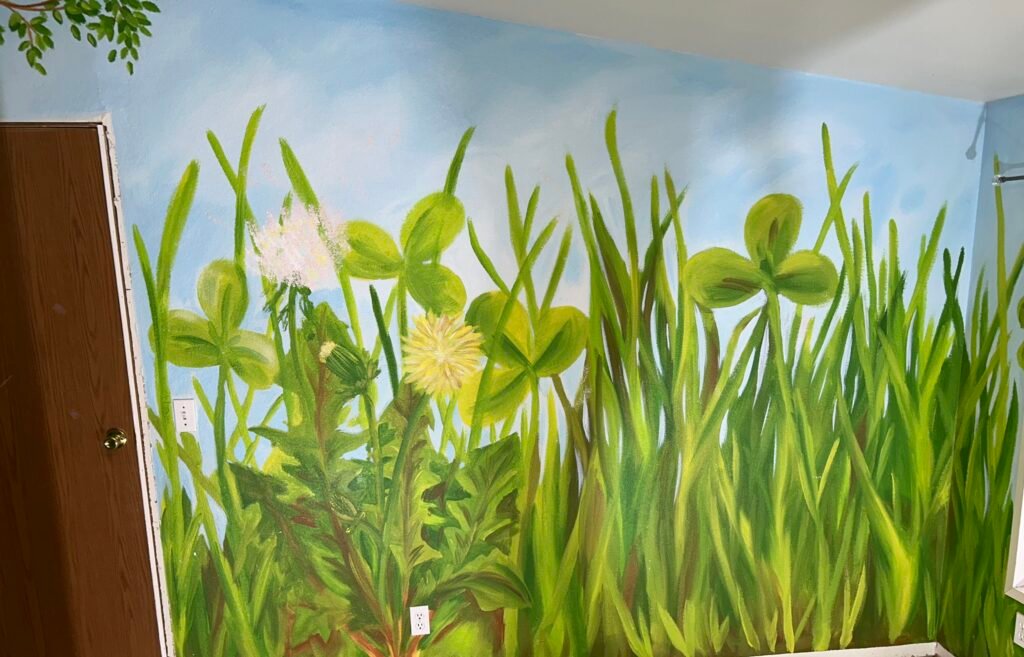 large grass and flowers painted on the wall